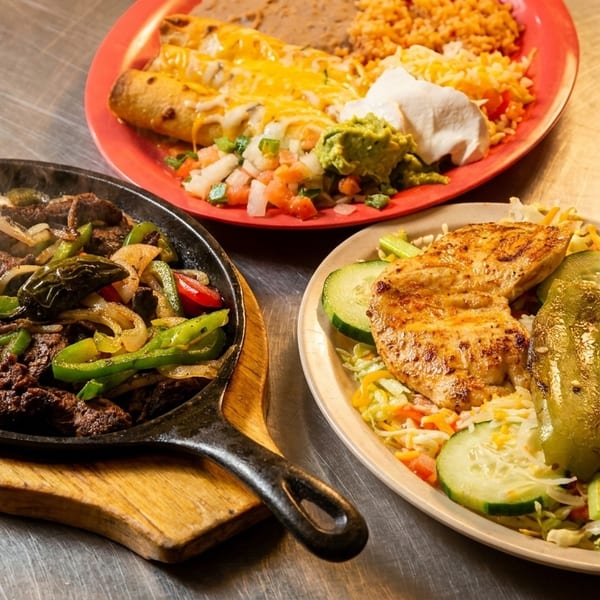 Sizzling beef fajitas, cheesy enchiladas with rice and beans, and grilled chicken with salad.